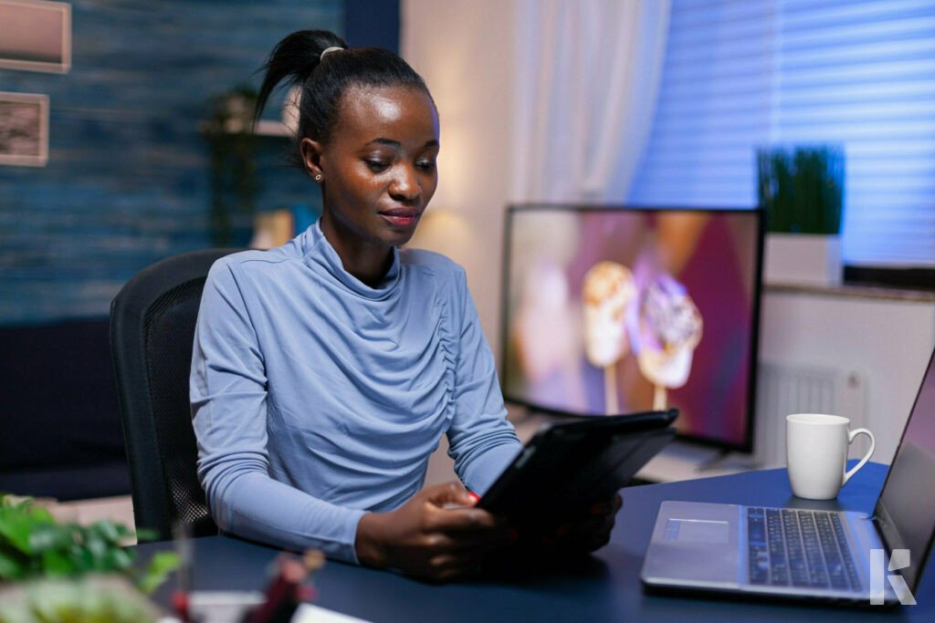 Woman working from home with a laptop and tablet